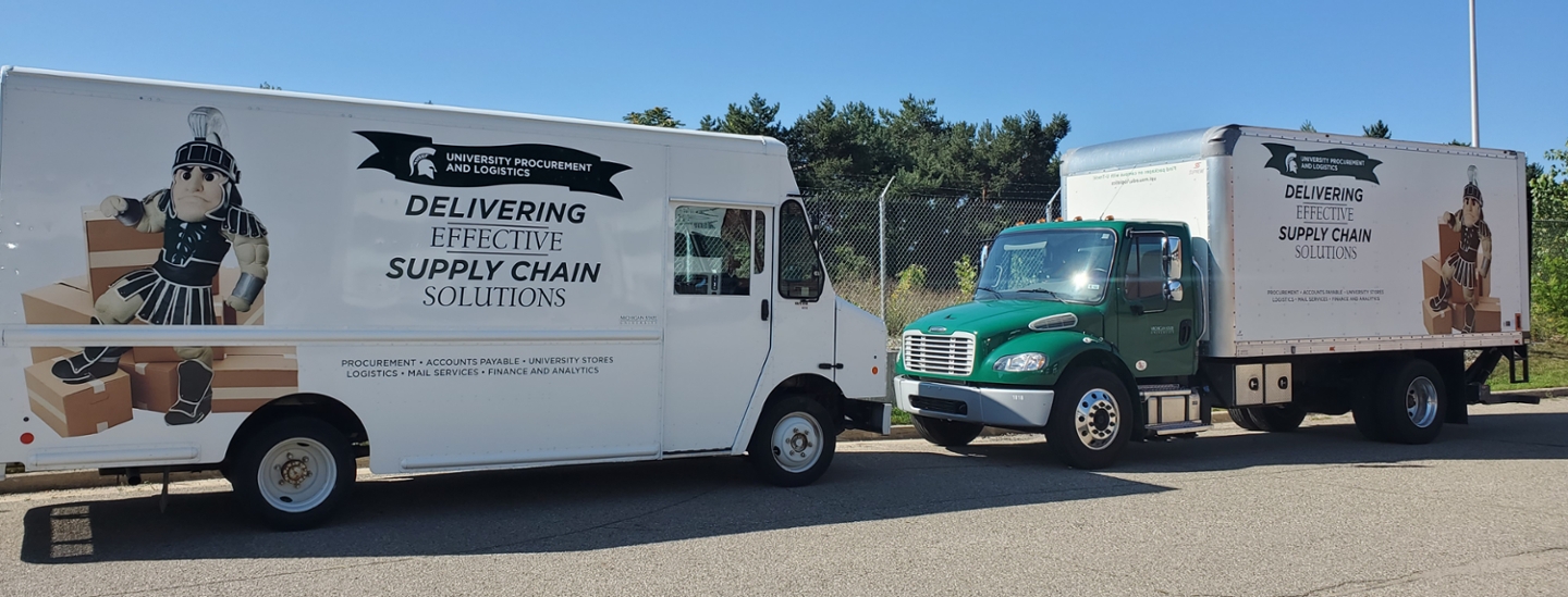 A line of University Procurement and Logistics delivery trucks