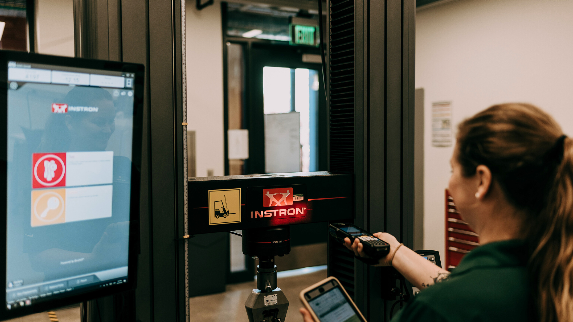 A woman tracking warehouse inventory using a computer software system. 