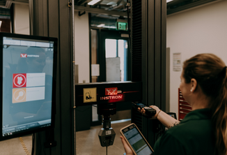 A woman tracking warehouse inventory using a computer software system. 